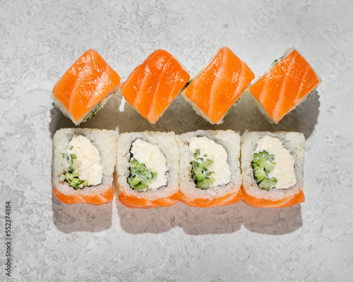 Philadelphia light roll, sushi, with sesame seeds, home-style, handmade, on an isolated stone background closeup top view