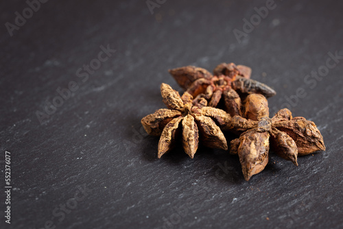 closeup of star anise on a black background, photographed from the top