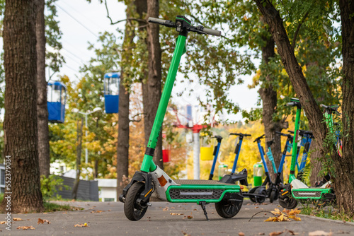 Electric Scooters in autumn park with cableway