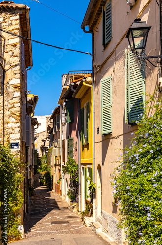 Fototapeta Naklejka Na Ścianę i Meble -  Rue des Revennes street with colorful vintage houses in historic old town of Antibes resort city onshore Azure Cost of Mediterranean Sea in France