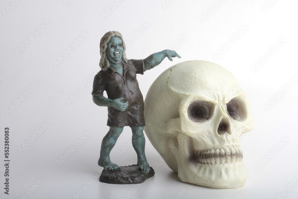 miniature figurine of a zombie doll on a white background miniature figurine of a zombie doll on a white background