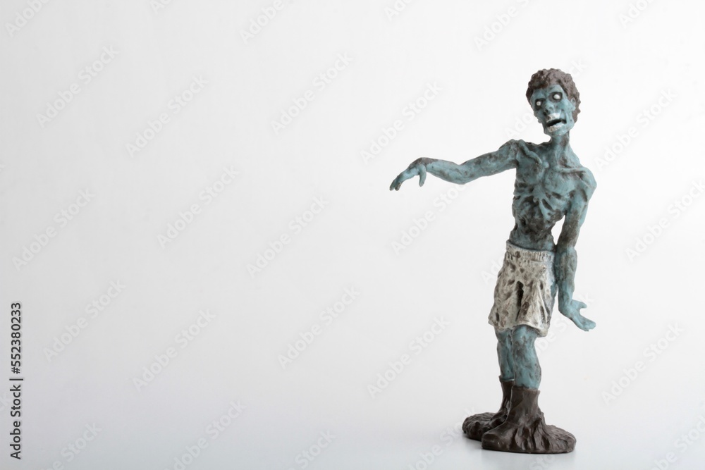 miniature figurine of a zombie doll on a white background miniature figurine of a zombie doll on a white background
