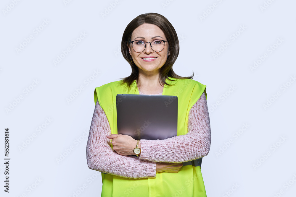 Portrait of engineer manager woman in vest holding laptop Portrait of engineer manager woman in vest holding laptop