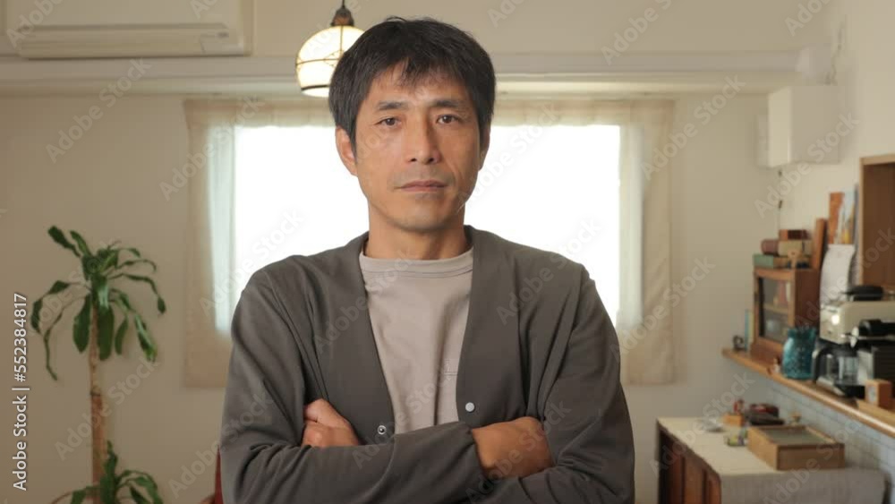 Middle aged asian man folds his arms to show his anger. Middle aged asian man folds his arms to show his anger.