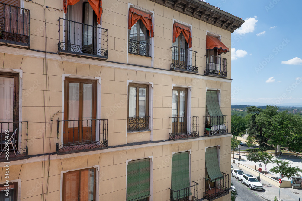 Obraz premium Facade of an old house with balconies and wooden windows overlooking the mountains