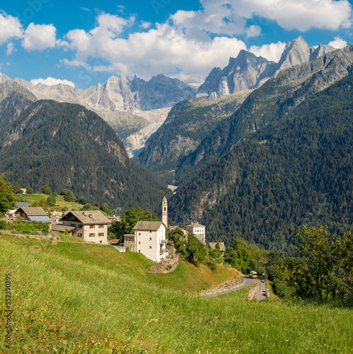 The Soglio village and Piz Badile, Pizzo Cengalo, and Sciora peaks in the Bregaglia range - Switzerland. photo