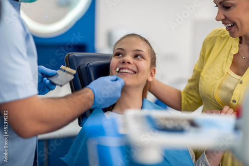 Young girl in stomatology clinic with male dentist