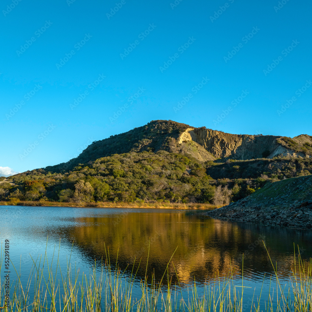 Lake Calaveras, volcanic Mt. Calavera, aqua plants, water reflections, tranquil landscape in Carlsbad, Southern California, USA
