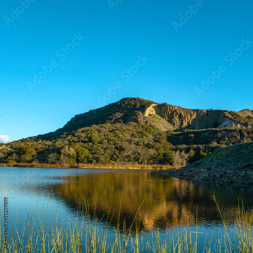 Lake Calaveras, volcanic Mt. Calavera, aqua plants, water reflections, tranquil landscape in Carlsbad, Southern California, USA © Naya Na