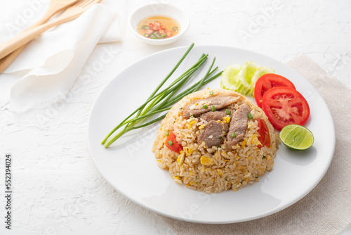 Easy Pork Fried Rice with egg and tomato in white plate.asian food