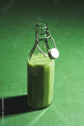 Green smoothie in glass bootle  photo