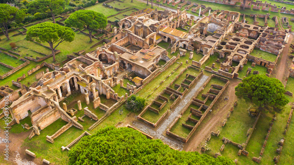 Aerial view of Baths of the Seven Sages. These ruins were thermal baths of Ostia Antica. In background there's the Sacellum of the Three Naves. The archaeological area is located in Ostia, Rome, Italy