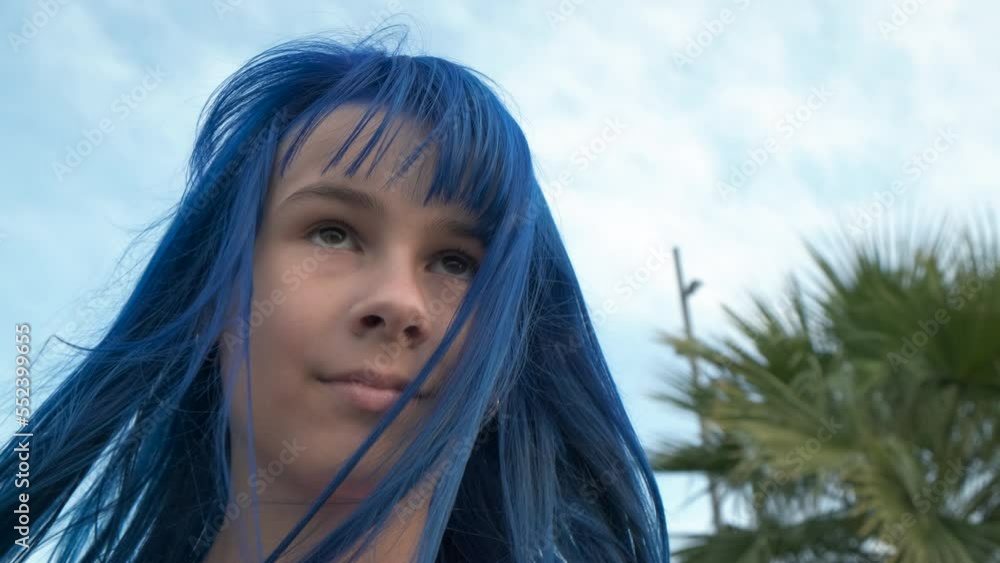 Enjoy turquoise hair style by sea. A happy teen girl with turquoise