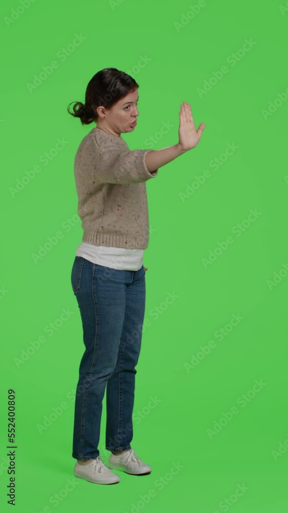 Vertical video Side view of woman doing stop talking sign with palm