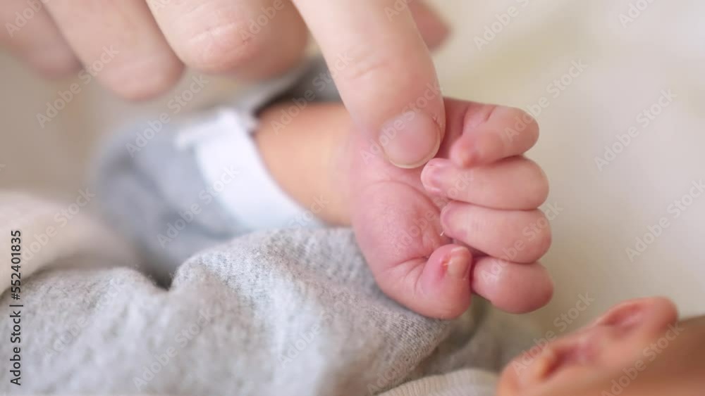 mother holding tiny hand of newborn baby. happy family a kid dream concept. baby hand holds mom finger. newborn care. sleeping baby hand lifestyle holding mom hand mother holding tiny hand of newborn baby. happy family a kid dream concept. baby hand holds mom finger. newborn care. sleeping baby hand lifestyle holding mom hand