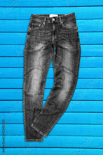 black jeans on wooden blue boards background photo