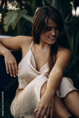 Portrait of beauriful woman by the green leaves photo