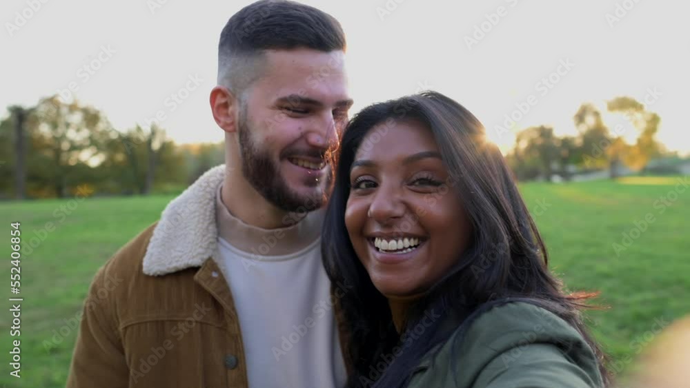 Young couple of lovers making a video call greeting friends and kissing, video memories of travel, valentines day concept Young couple of lovers making a video call greeting friends and kissing, video memories of travel, valentines day concept