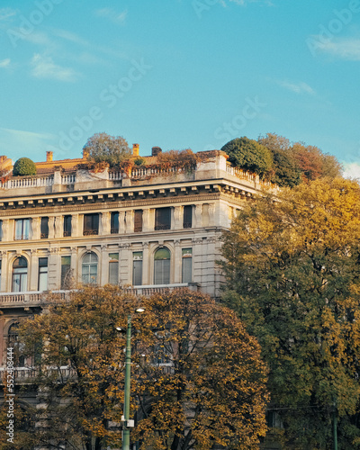 European building covered in trees photo