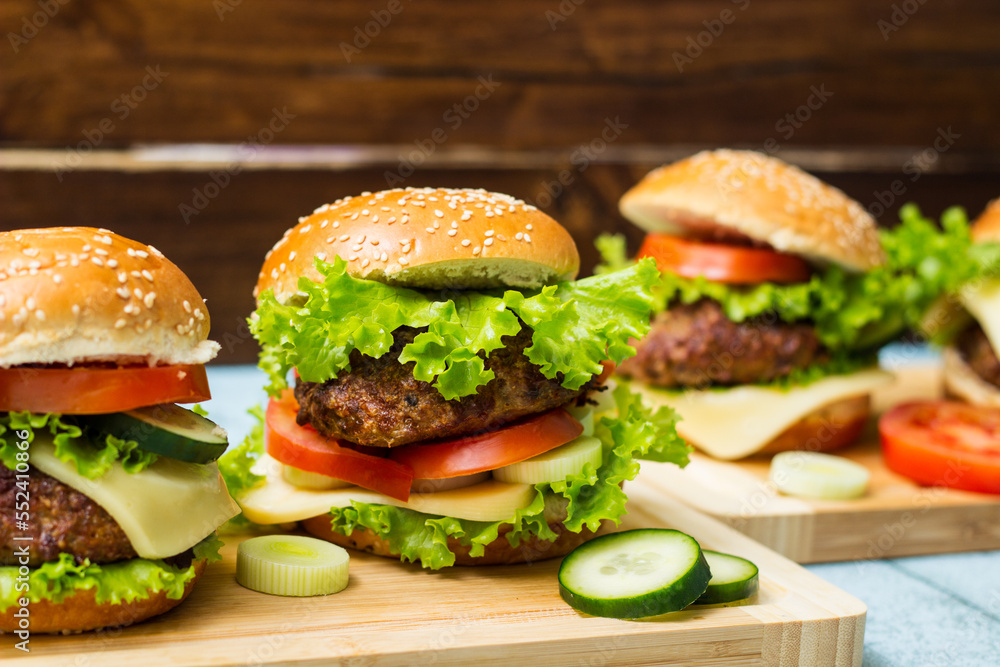 Fresh grilled burgers served on wood table Fresh grilled burgers served on wood table