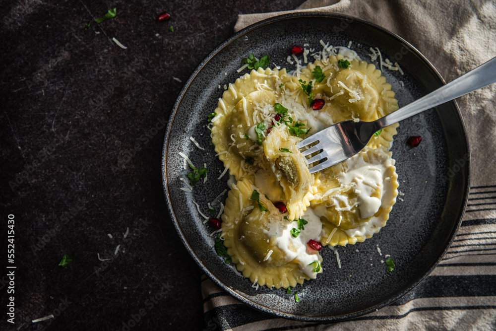 Mezzelune filled with parmesan and asparagus with creamy sauce. - obrazy, fototapety, plakaty 