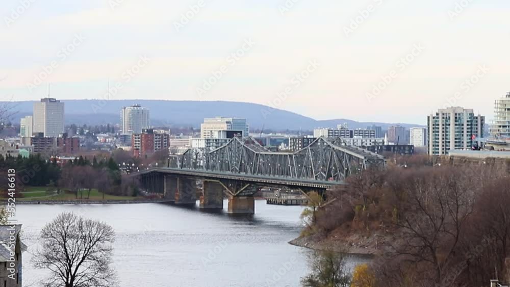 Rideau canal in Ottawa, Canada. View on Ottawa river, Alexandra bridge and Gatineau city of Quebec in autumn season. Rideau canal in Ottawa, Canada. View on Ottawa river, Alexandra bridge and Gatineau city of Quebec in autumn season.