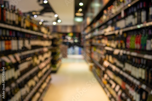 Wallpaper Mural Blurred image of wine shelves display in supermarket Torontodigital.ca