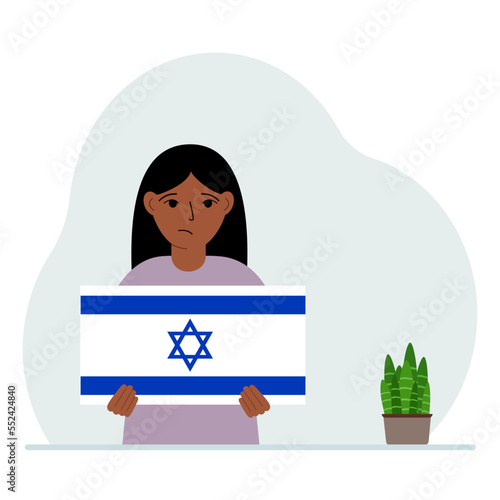 A little girl holds the flag of Israel in his hands. The concept of demonstration, national holiday or patriotism. Nationality.