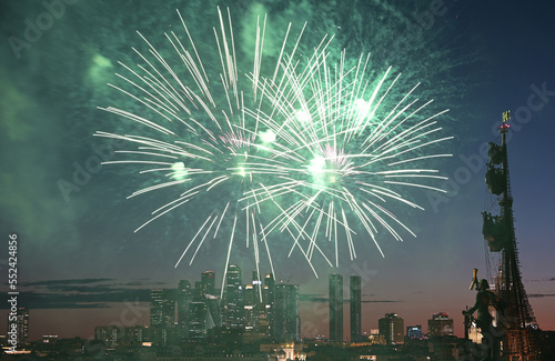 Fireworks over the monument to Peter the Great and Moscow City skyscrapers on a summer evening.
