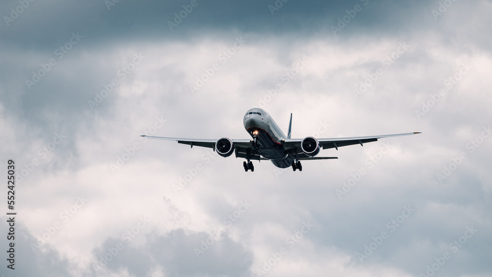 Passenger plane comes in for landing in cloudy weather. Passenger plane comes in for landing in cloudy weather.