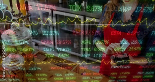 Animation of multicolored trading board over caucasian female barista swiping credit card on reader photo