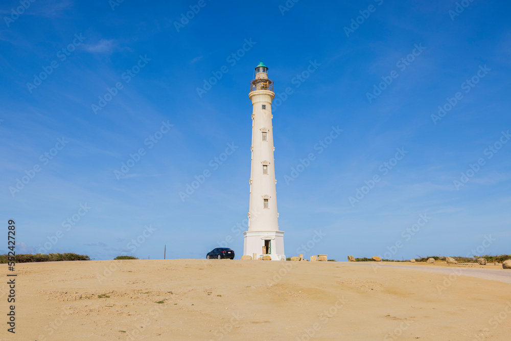 California lighthouse in desert against blue sky of southern coast of island of Aruba.