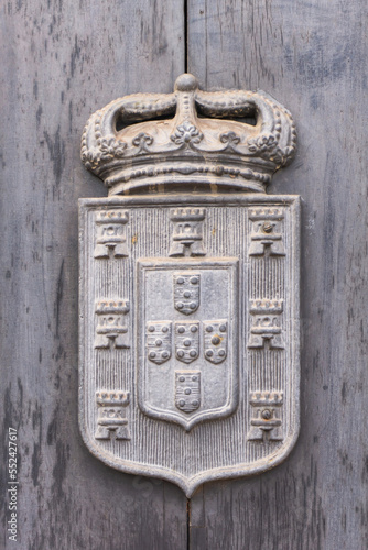 Ancient Portuguese coat of arms with crown, towers and shields