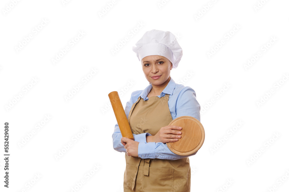 Confident female pastry chef portrait in professional uniform posing with wooden cutting board and rolling pin, over white background with free advertising space. Baking. Culinary master class concept Confident female pastry chef portrait in professional uniform posing with wooden cutting board and rolling pin, over white background with free advertising space. Baking. Culinary master class concept