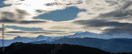Beautiful lenticular clouds over the snowy peaks of Sierra Nevada  Granada  Spain 