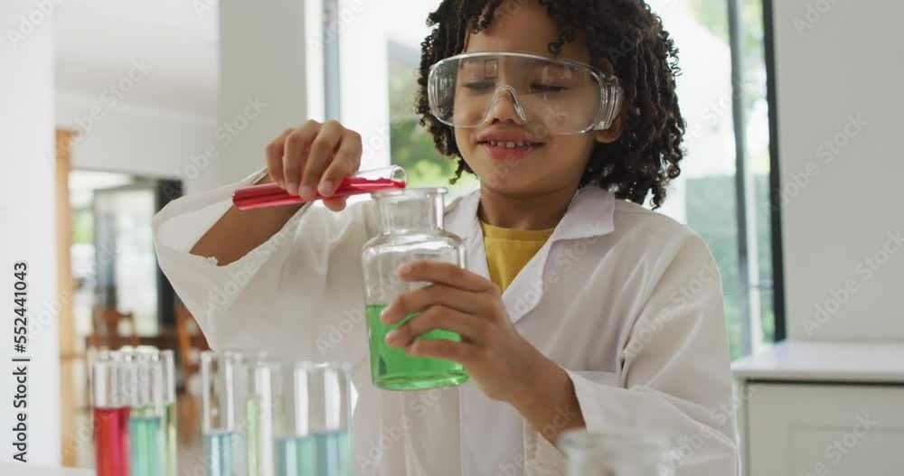 Animation of shapes over african american schoolboy at science class Animation of shapes over african american schoolboy at science class