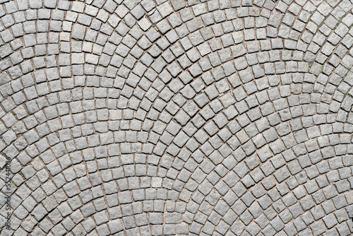 фотографія Grey cobblestone pavement abstract background surface top close up view