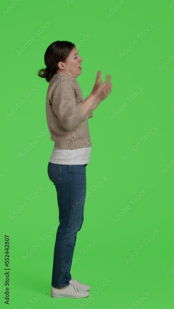 Vertical video: Profile of frustrated person acting displeased on full body greenscreen, showing disagreement and disapproval over green screen backdrop. Mad furious woman being disappointed in studio Vertical video: Profile of frustrated person acting displeased on full body greenscreen, showing disagreement and disapproval over green screen backdrop. Mad furious woman being disappointed in studio