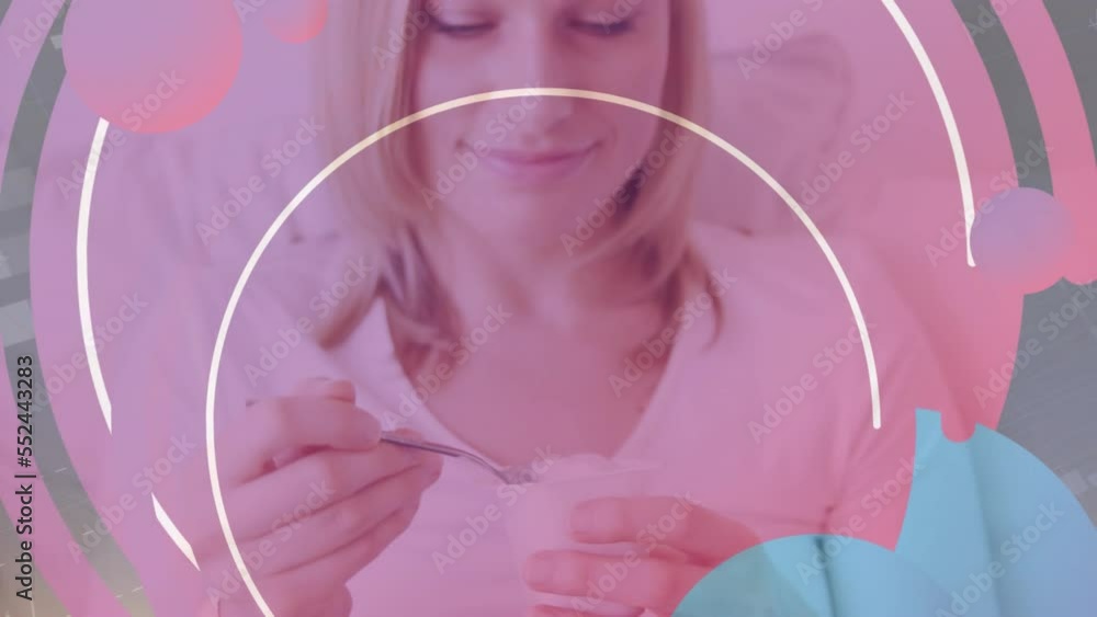 Animation of pattern over woman eating yoghurt Animation of pattern over woman eating yoghurt