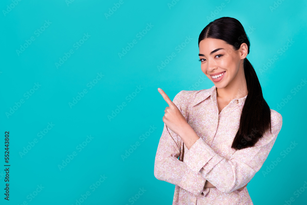 Portrait of cheerful pretty filipino person indicate finger empty space proposition isolated on turquoise color background Portrait of cheerful pretty filipino person indicate finger empty space proposition isolated on turquoise color background