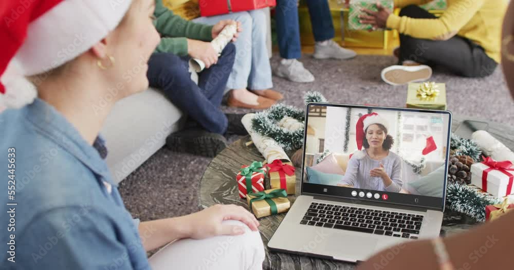 Diverse group of friends having christmas video call with african american woman
