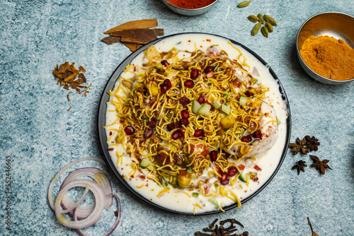 Papricha chotpoti with pomegranate seeds served in a dish isolated on grey background top view of bangladesh food photo
