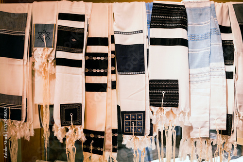 Jewish tallits used for the Jewish man hanging near the ancient synagogue in Israel Prayer Shawl - Tallit, jewish religious symbol photo