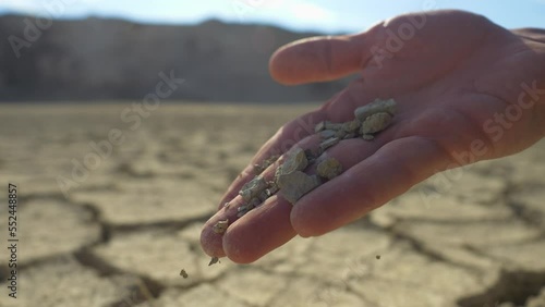 Dry soil in farmers hands, drought season. Sustainable agriculture and food production. Food crisis, hunger and malnutrition due to the climate change and lack of water. Efficient resource use concept