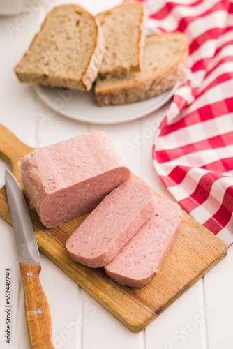 Luncheon meat on cutting board.
