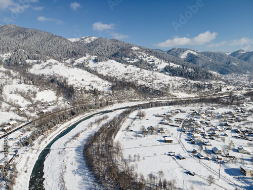 Carpathians village Kryvorivnia in the mountains covered by snow. Ukraine photo