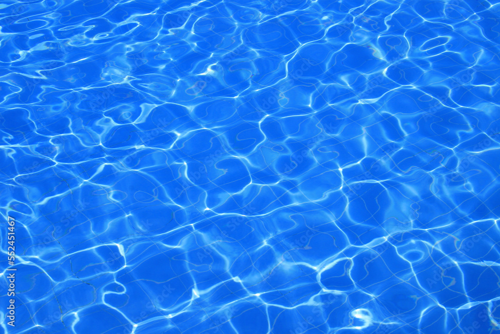Sunlight shining on a blue swimming pool