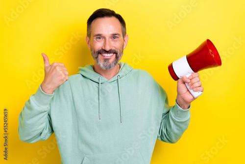 Photo of old age mature aged brunet hair grey beard activist recommend bullhorn protest against low salary isolated on yellow color background