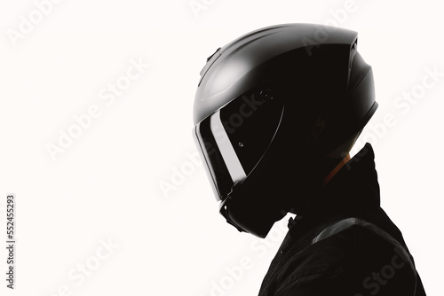 Fototapeta Portrait of a motorcycle rider posing with a black helmet on a white background