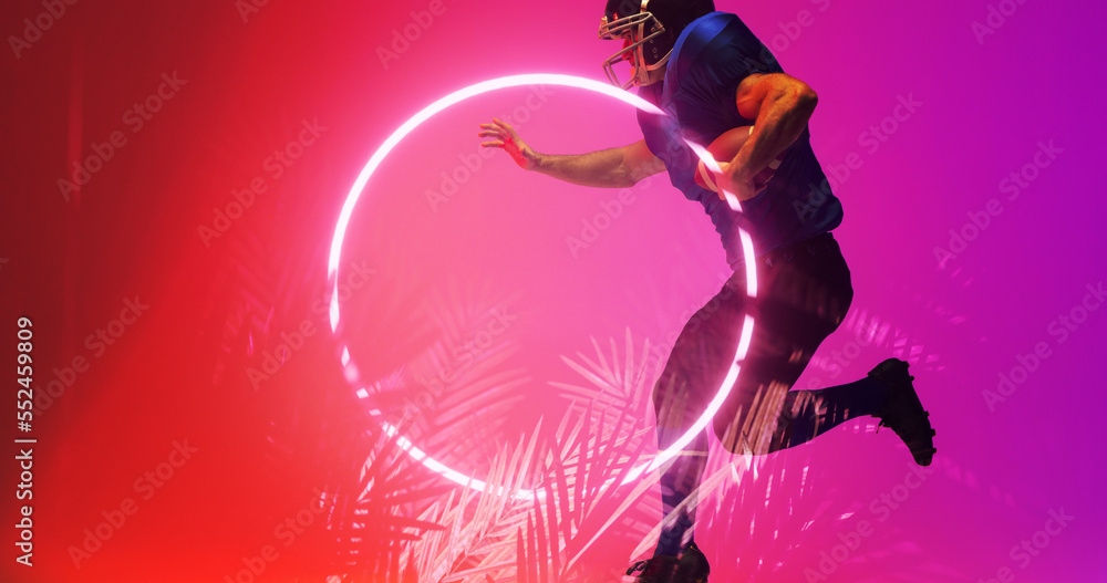 American football player holding ball and running by illuminated circle and plants, copy space